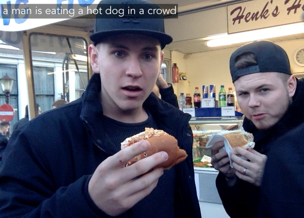 Automatically captioned image; caption reads: "a man is eating a hot dog in a crowd"